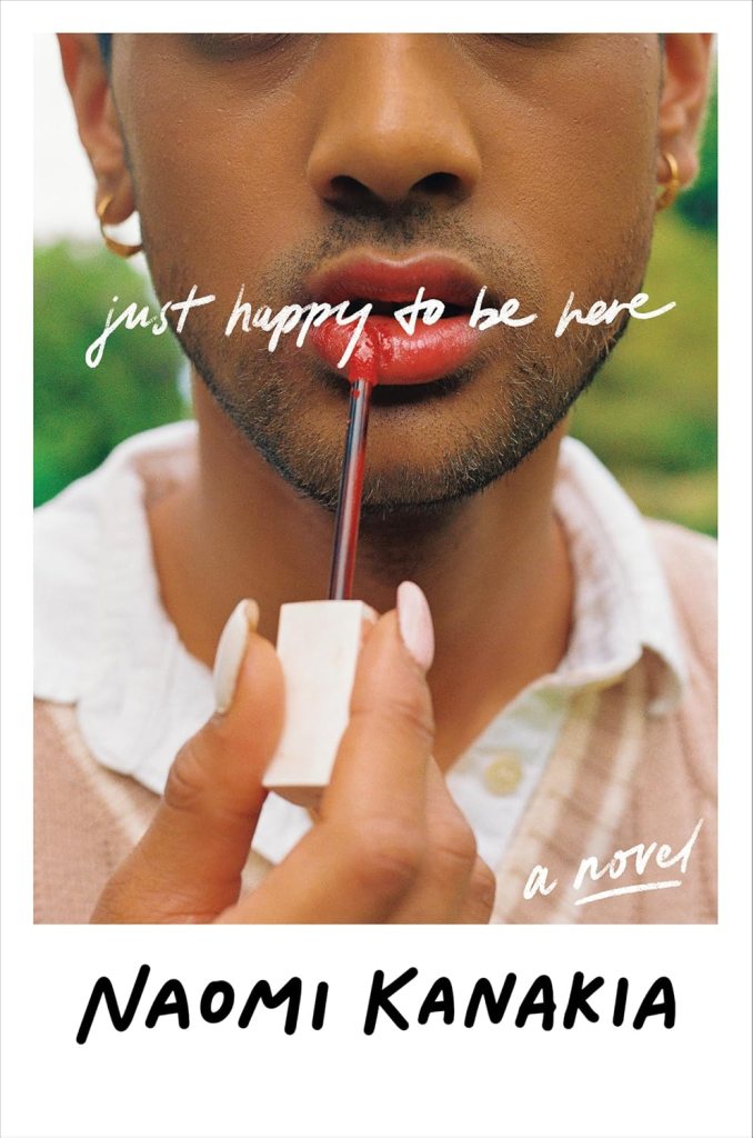 Just happy to be here by Naomi kanakia has a picture of a dark-skinned bearded person applying red lipstick outside