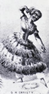 A man poses like a ballerina in a poofy dress and blackface