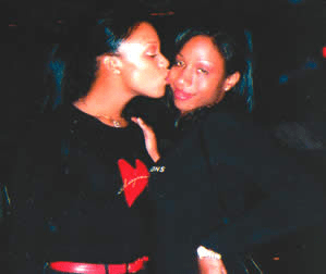 A photo of stephanie thomas and Ukea Davis, two young black trans women, posing with a kiss for the camera.